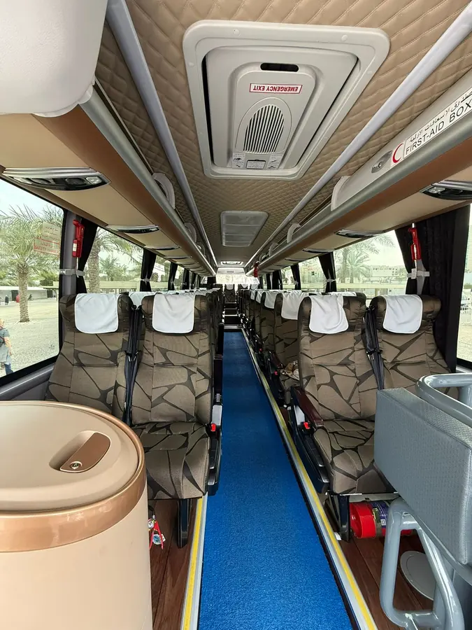 Reclining seats along the aisle of a Dunescape touring coach