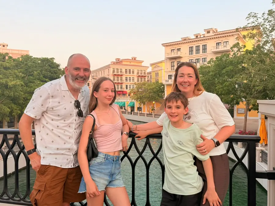 A family of four on the canal bridge at Qanat Quartier