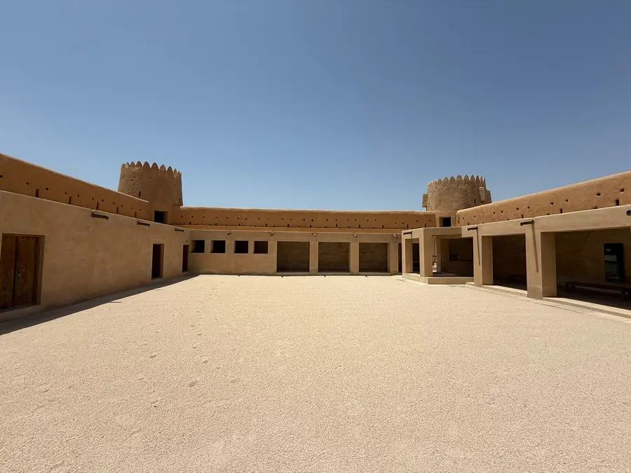 The empty sand courtyard of a restored desert fort