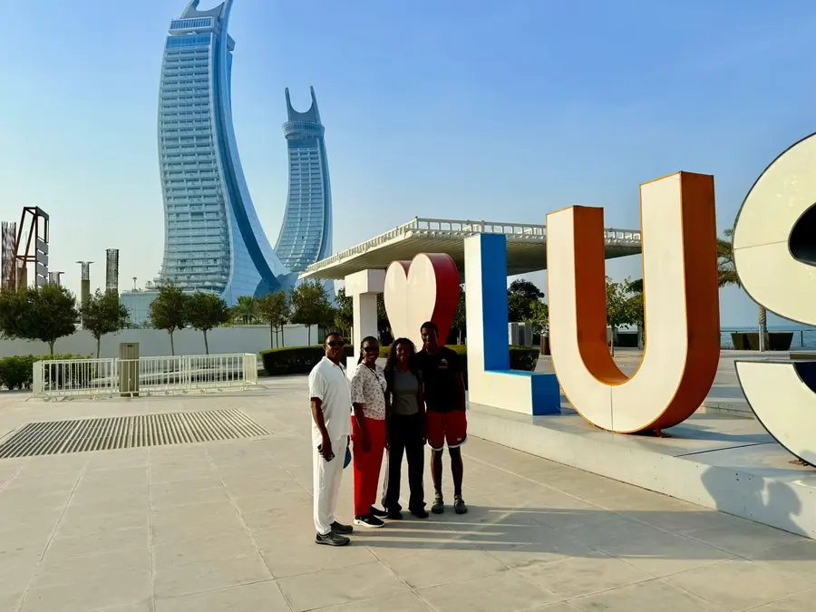A group at the I Love Lusail sign on the marina promenade