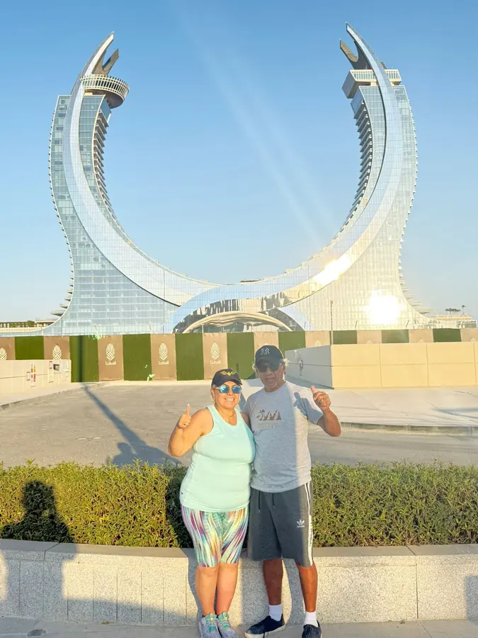 Guests posing beneath the Katara Towers in Lusail