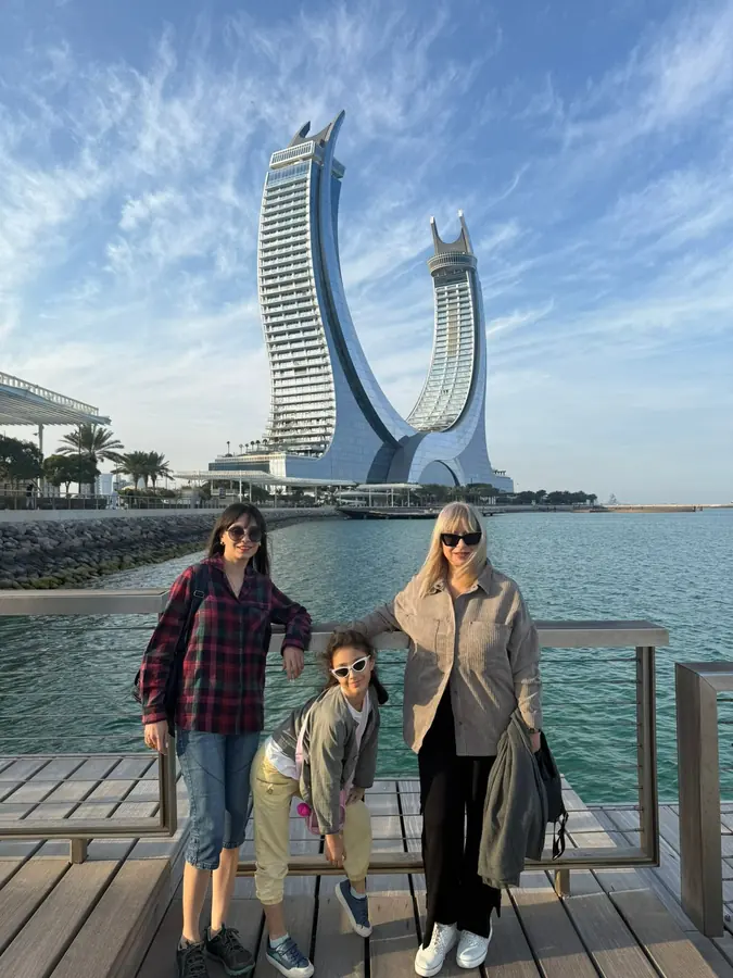 Guests on the Lusail Marina boardwalk with the Katara Towers rising behind