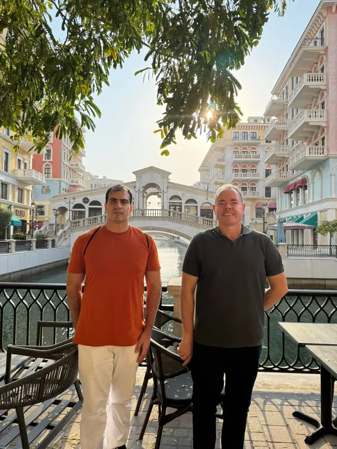 Two guests beside the canal at Qanat Quartier
