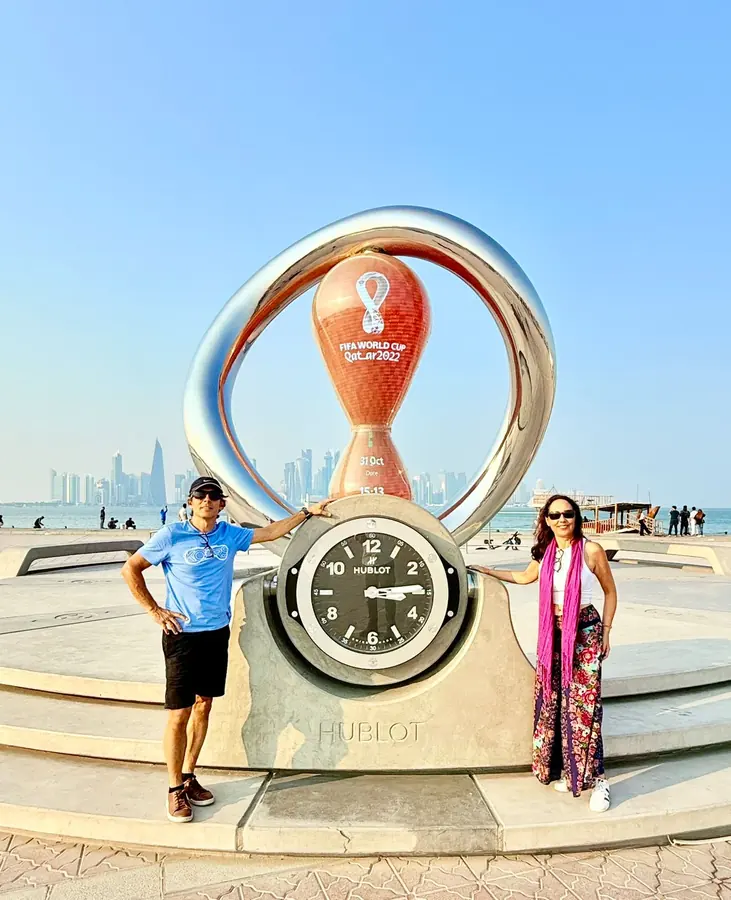 Guests either side of the World Cup countdown clock on the Corniche